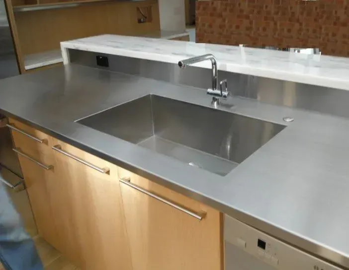 A kitchen with a stainless steel sink and a dishwasher