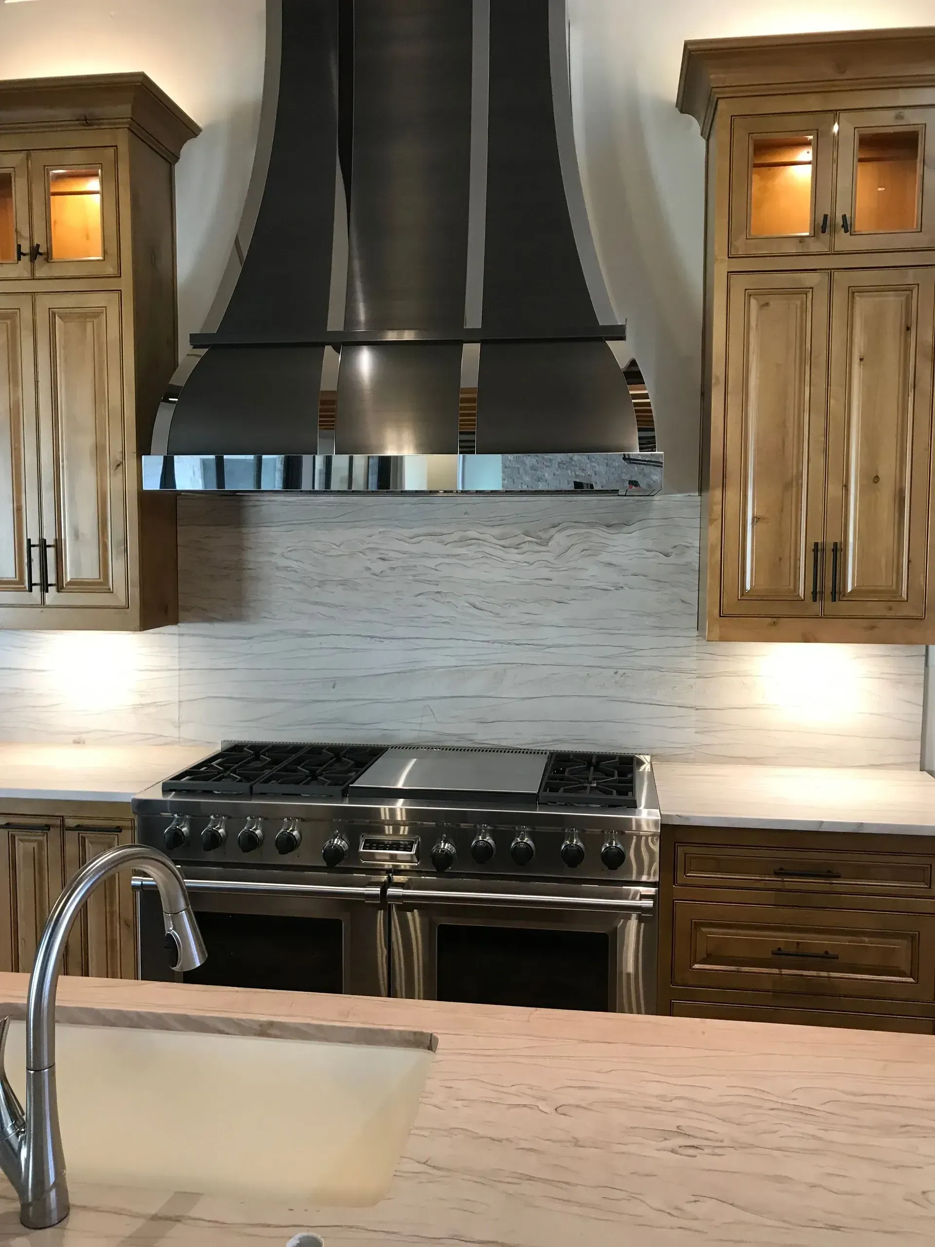 A kitchen with stainless steel appliances and wooden cabinets