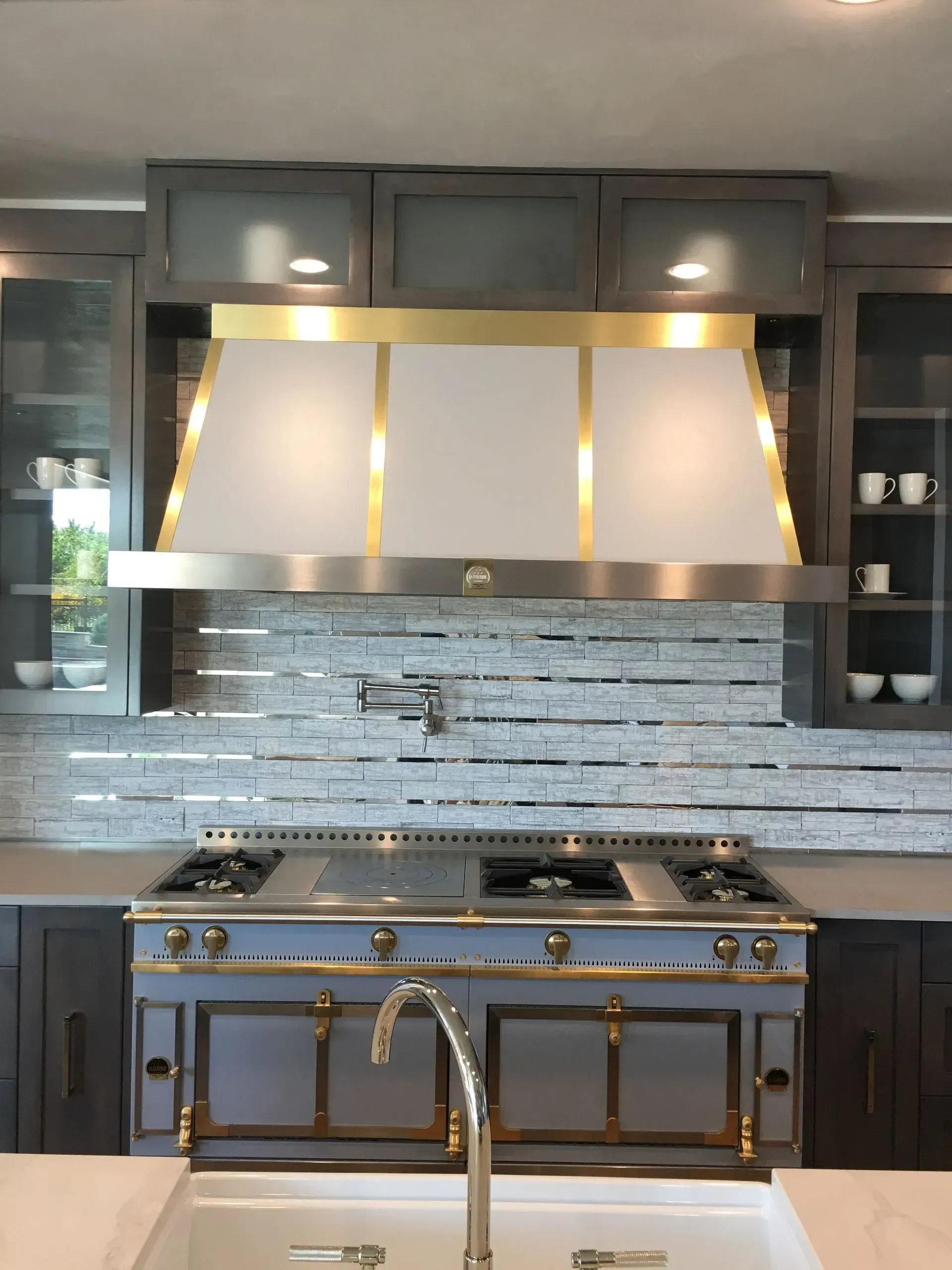A kitchen with a stove top oven and a sink