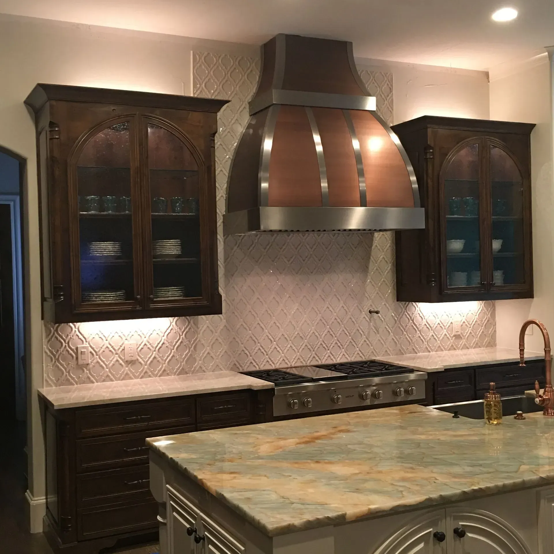 A kitchen with a copper hood above the stove