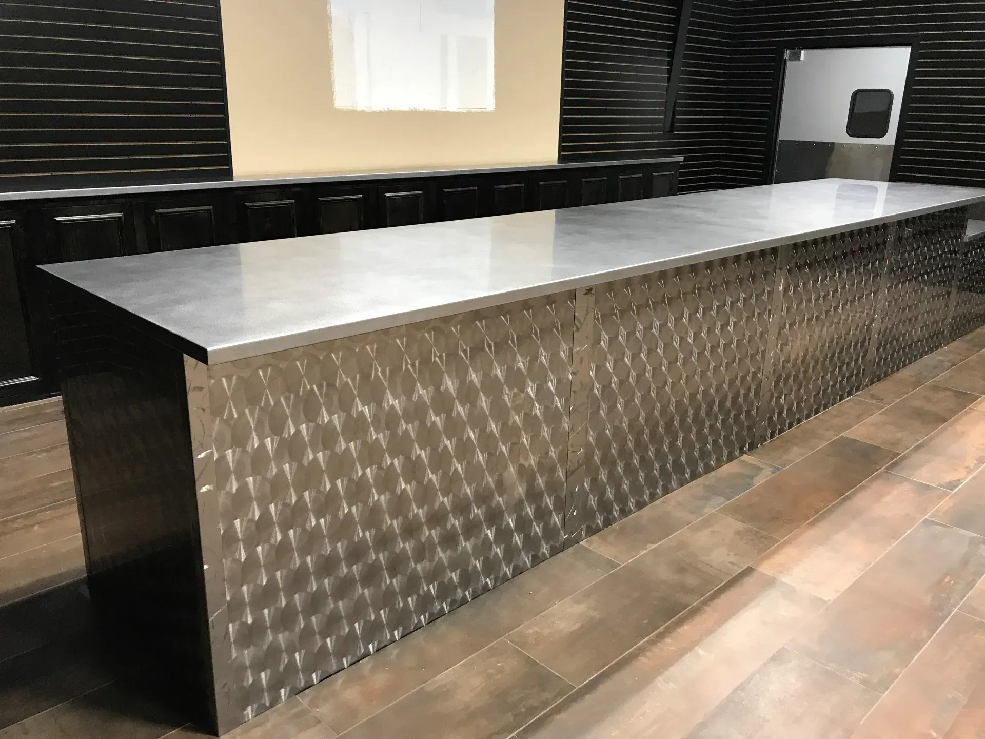 A long stainless steel counter top in a kitchen