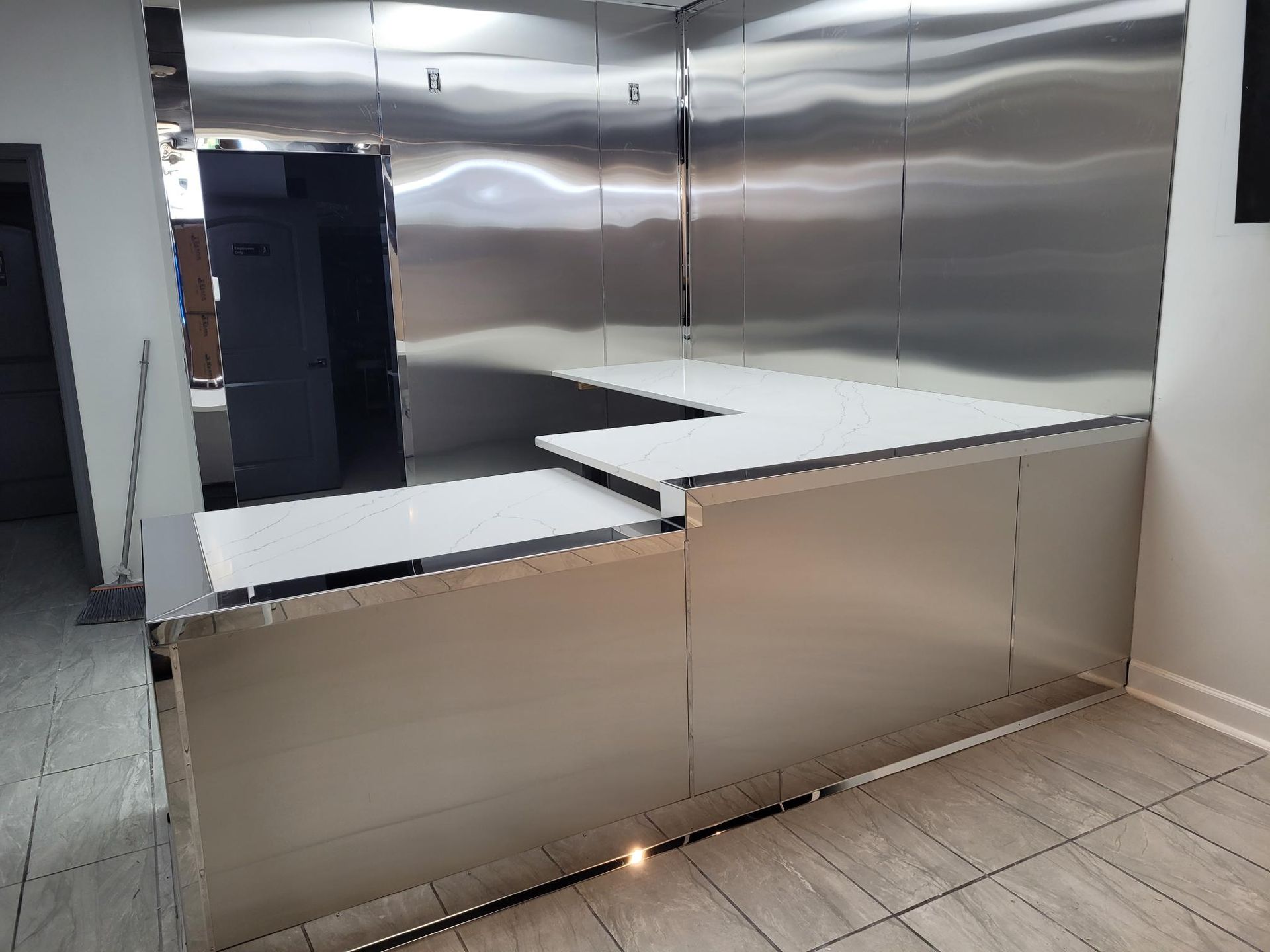 A kitchen with stainless steel walls and a counter top.
