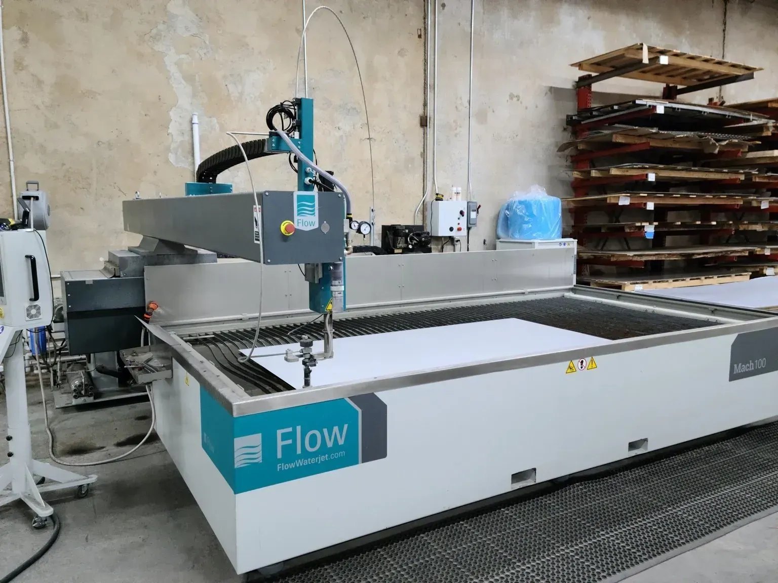 A machine with the word flow on it is sitting in a warehouse.