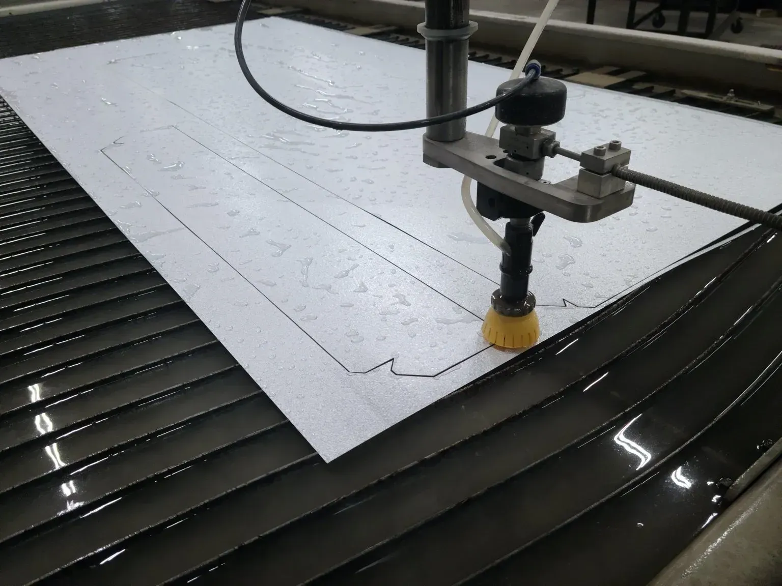 A machine is cutting a piece of paper on a table