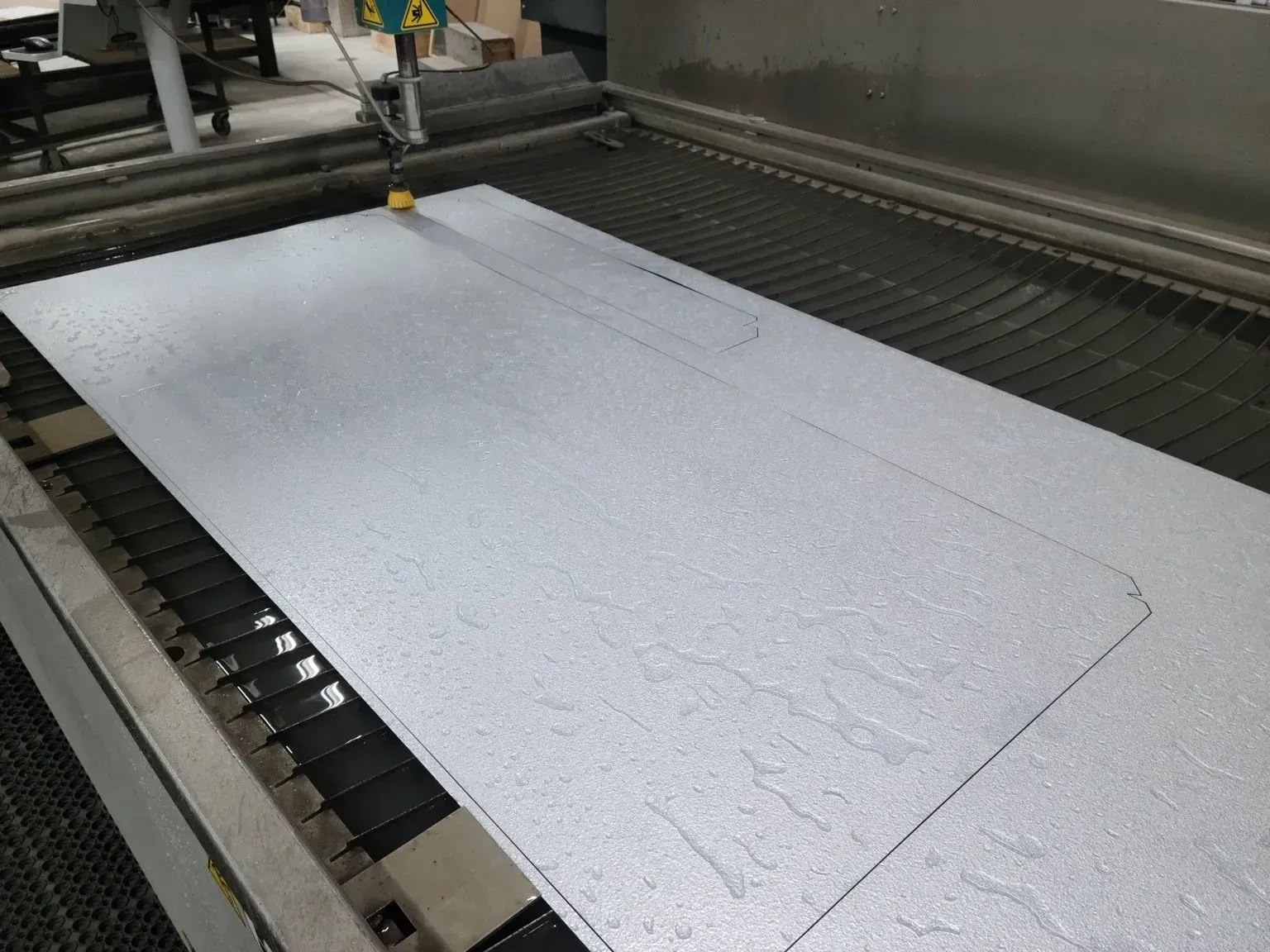 A large piece of foam is being cut by a machine.