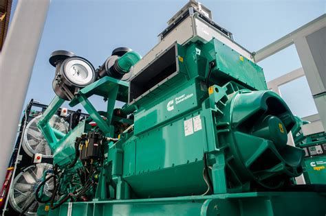Large, green Cummins diesel generator on a platform.