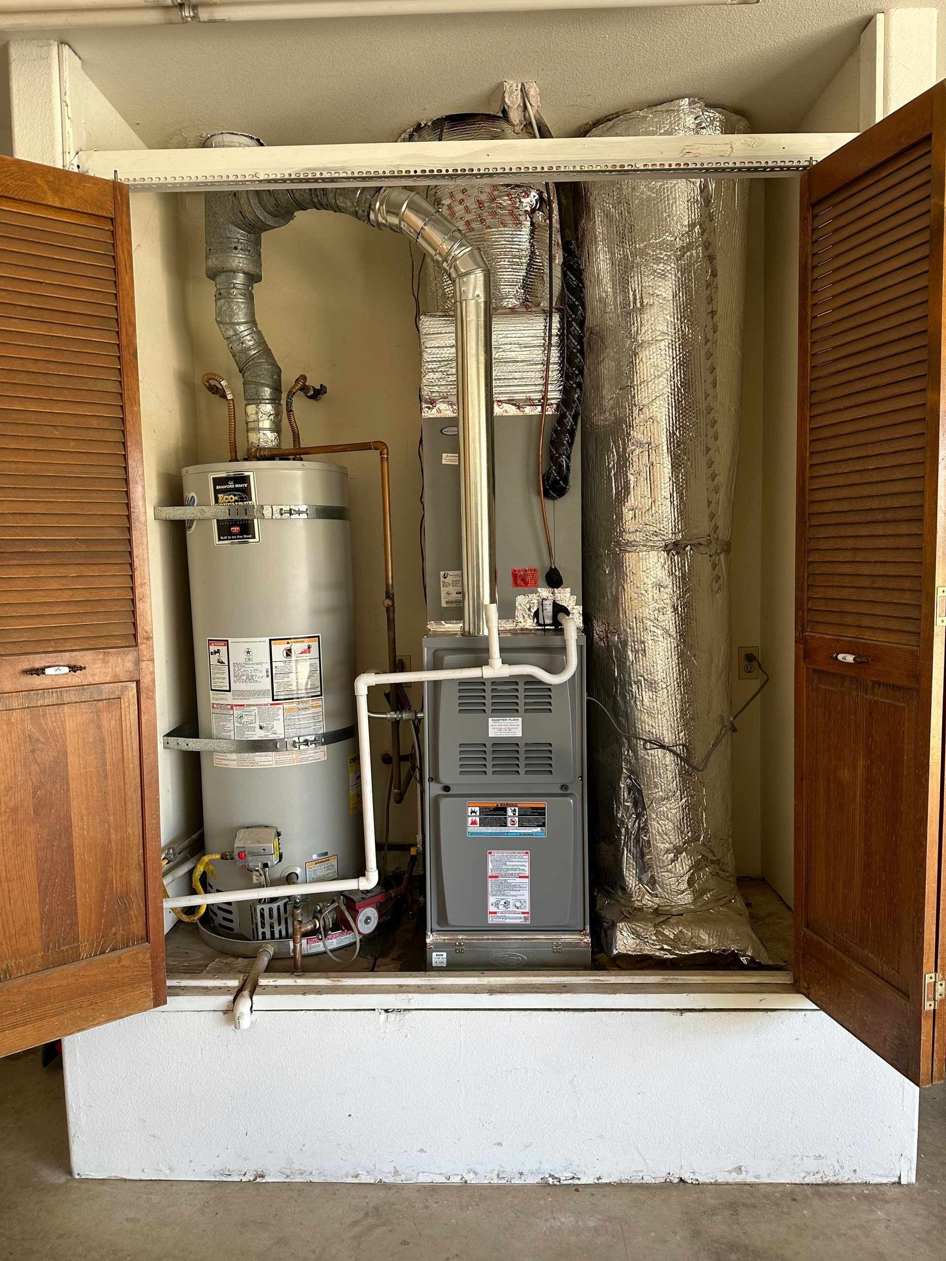 A water heater and an air conditioner in a closet