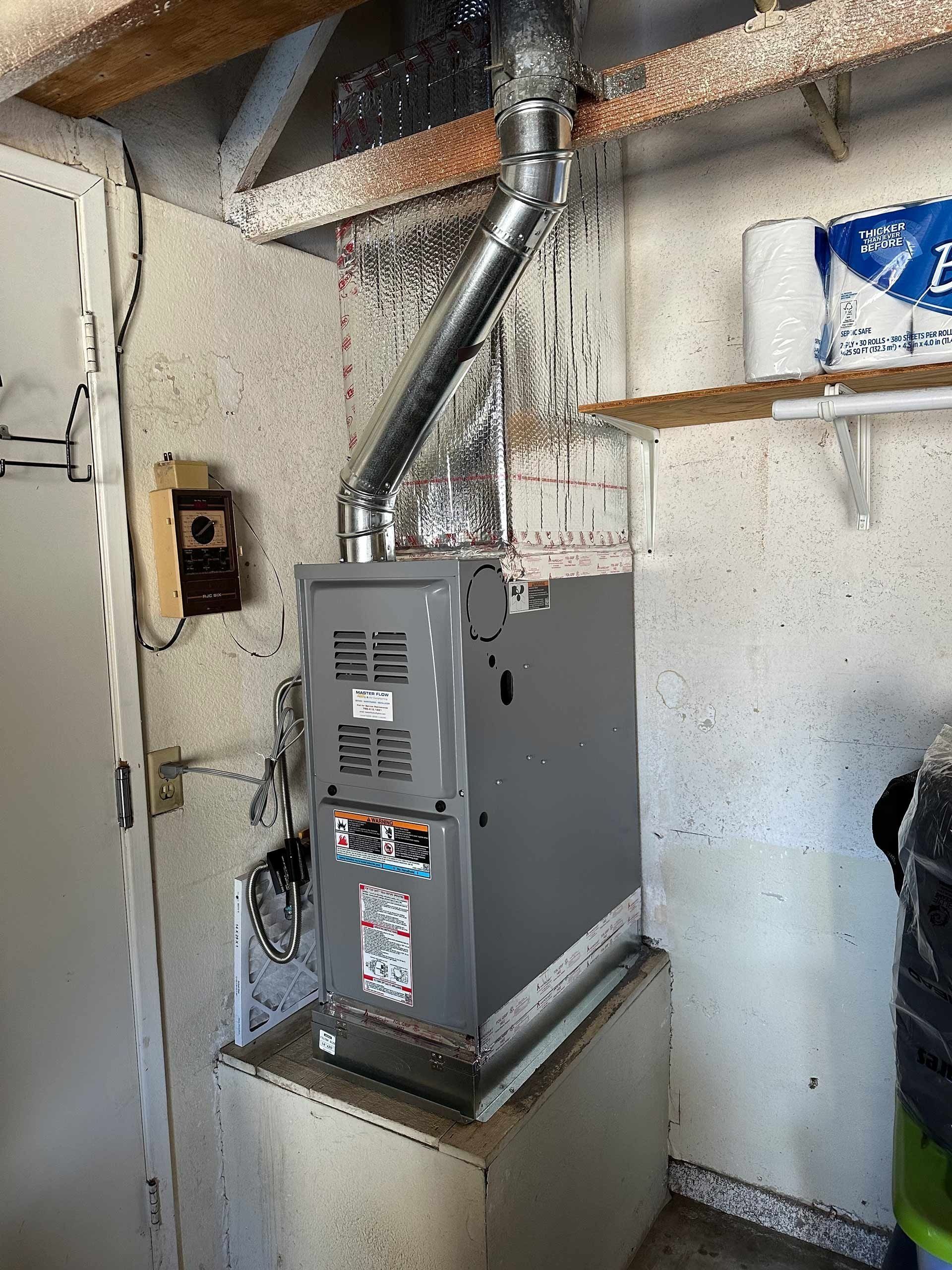 A heater is sitting on top of a shelf in a room.
