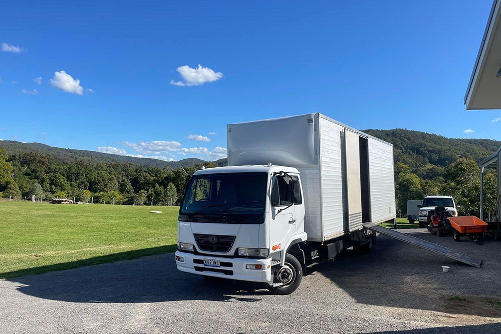 White Transport Truck Parked In A Clear Sky Weather — Removals in Newcastle, NSW