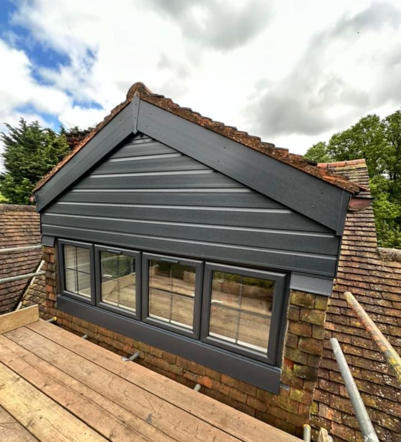 A roof with a window and scaffolding on it