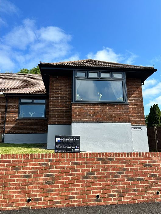 A brick house with a brick wall in front of it