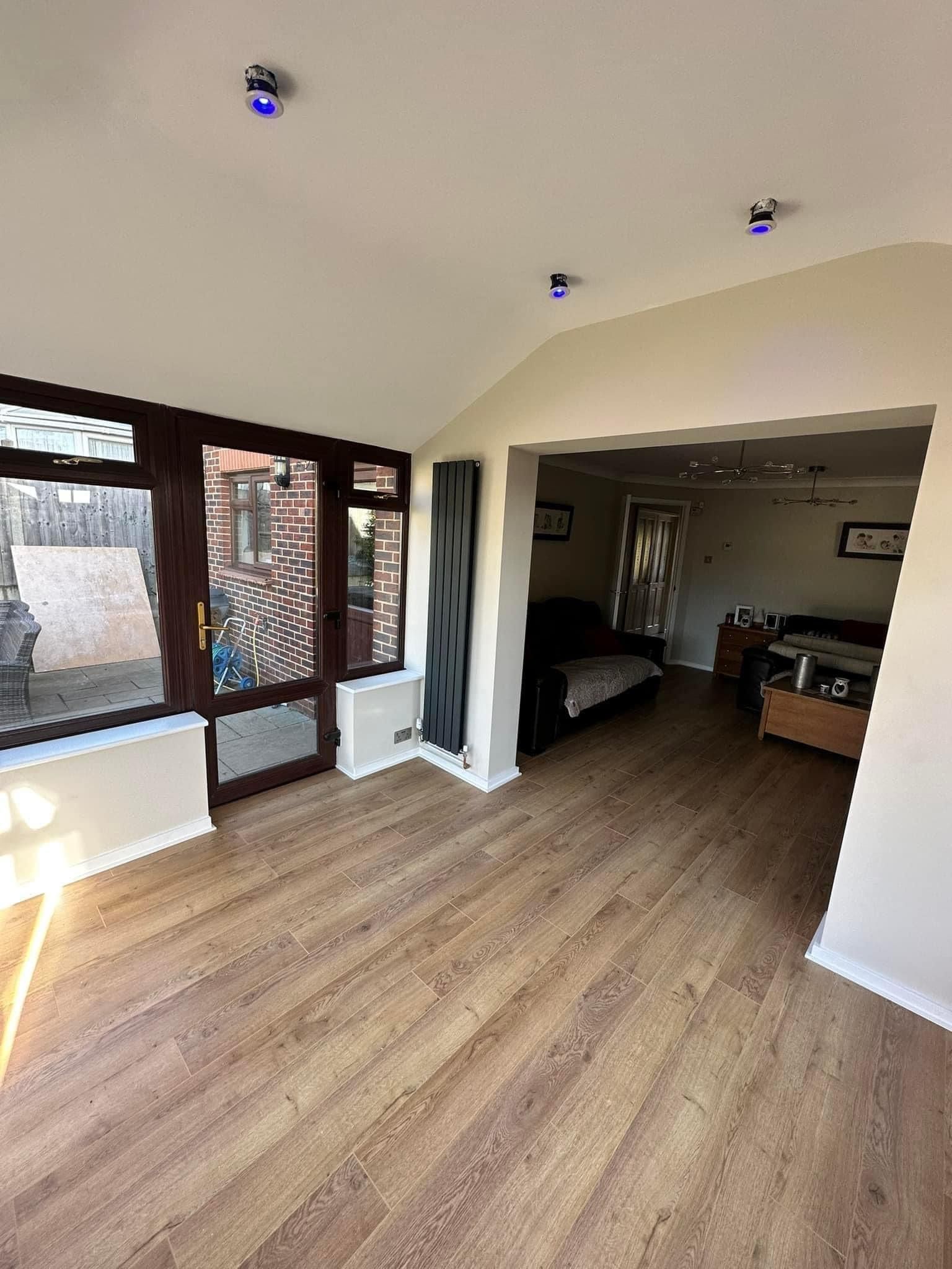 A living room with hardwood floors and a couch.