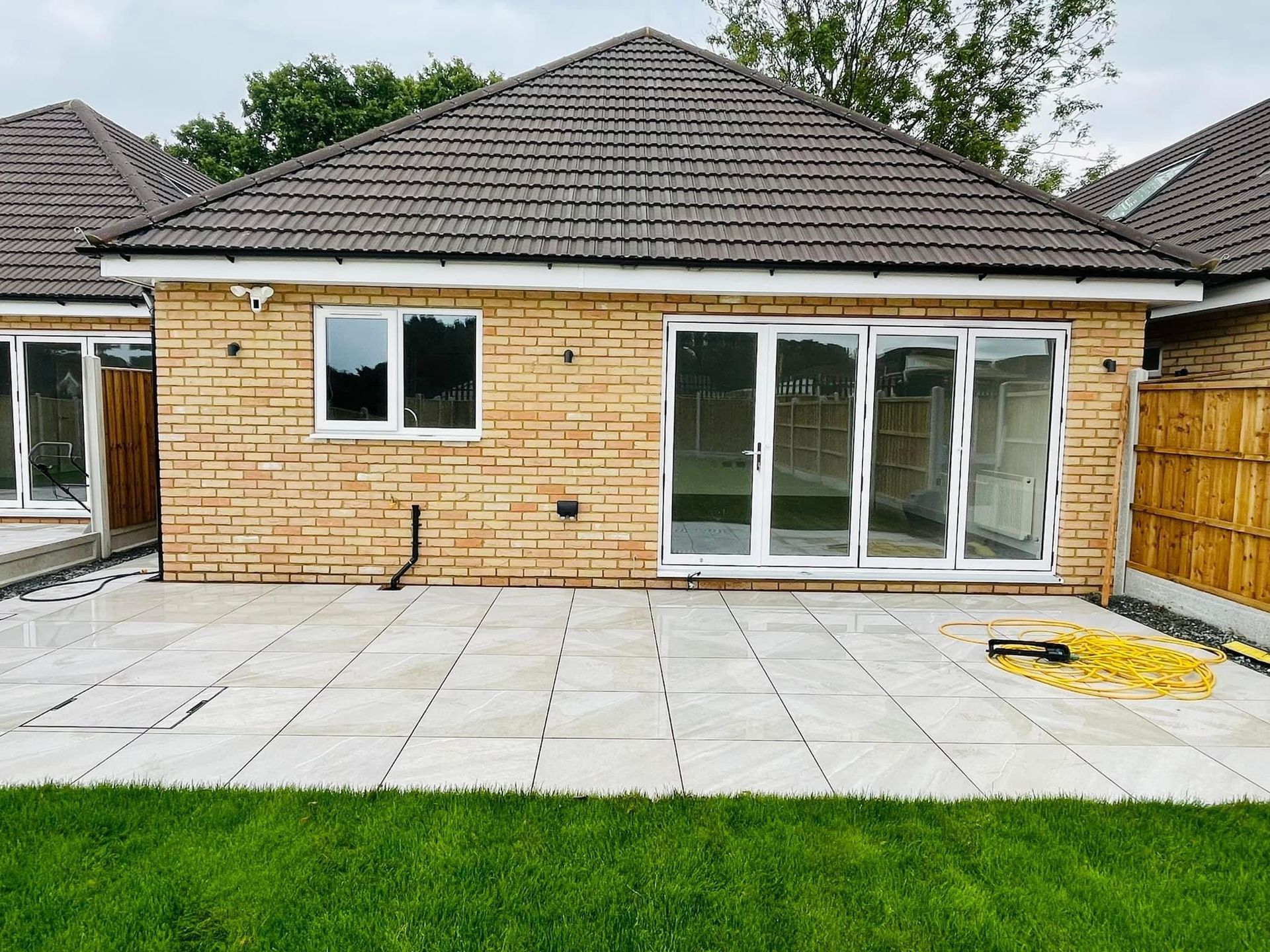A brick house with a patio in front of it.