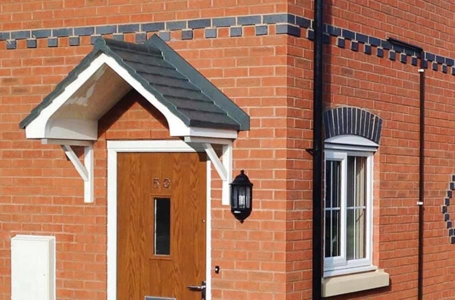 A brick house with a wooden door and a window