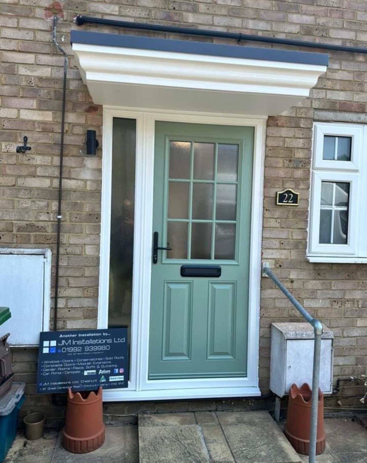 The front door of a brick house with a green door
