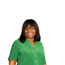 Woman with glasses smiles, wearing a green shirt, standing in front of a white background.
