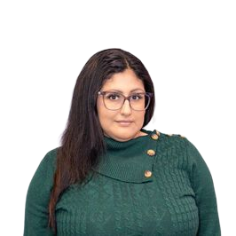 Woman with glasses wearing a green sweater, posing in front of a white background.