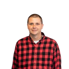 Man in red and black plaid shirt smiles against a white backdrop.