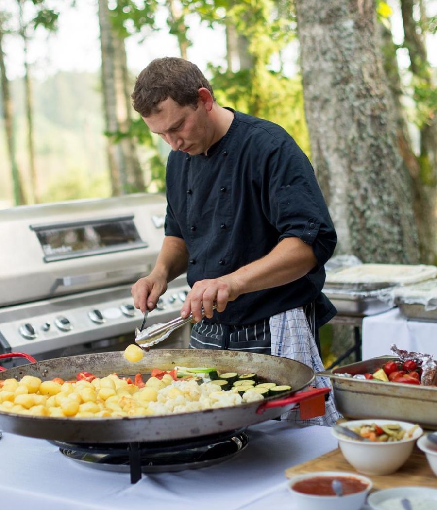 person cooking on grill  outdoor kitchen