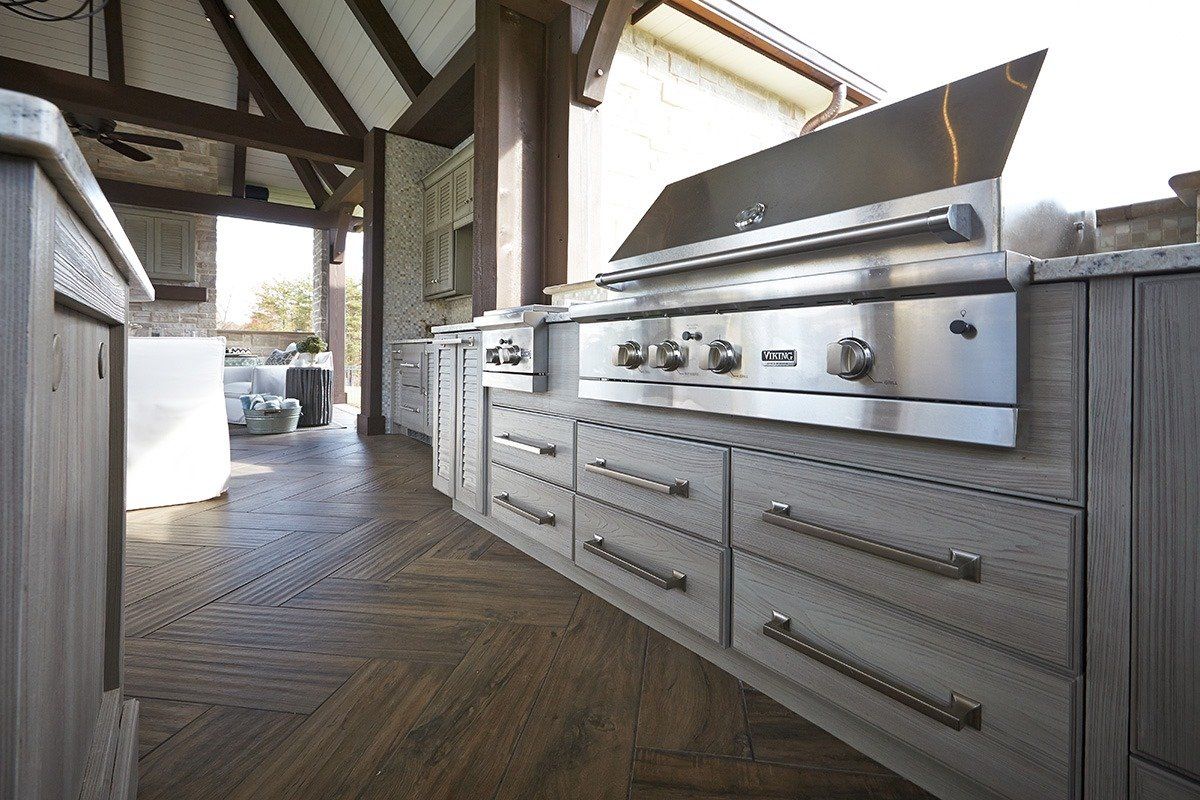 a custom outdoor kitchen with a stainless steel barbeque