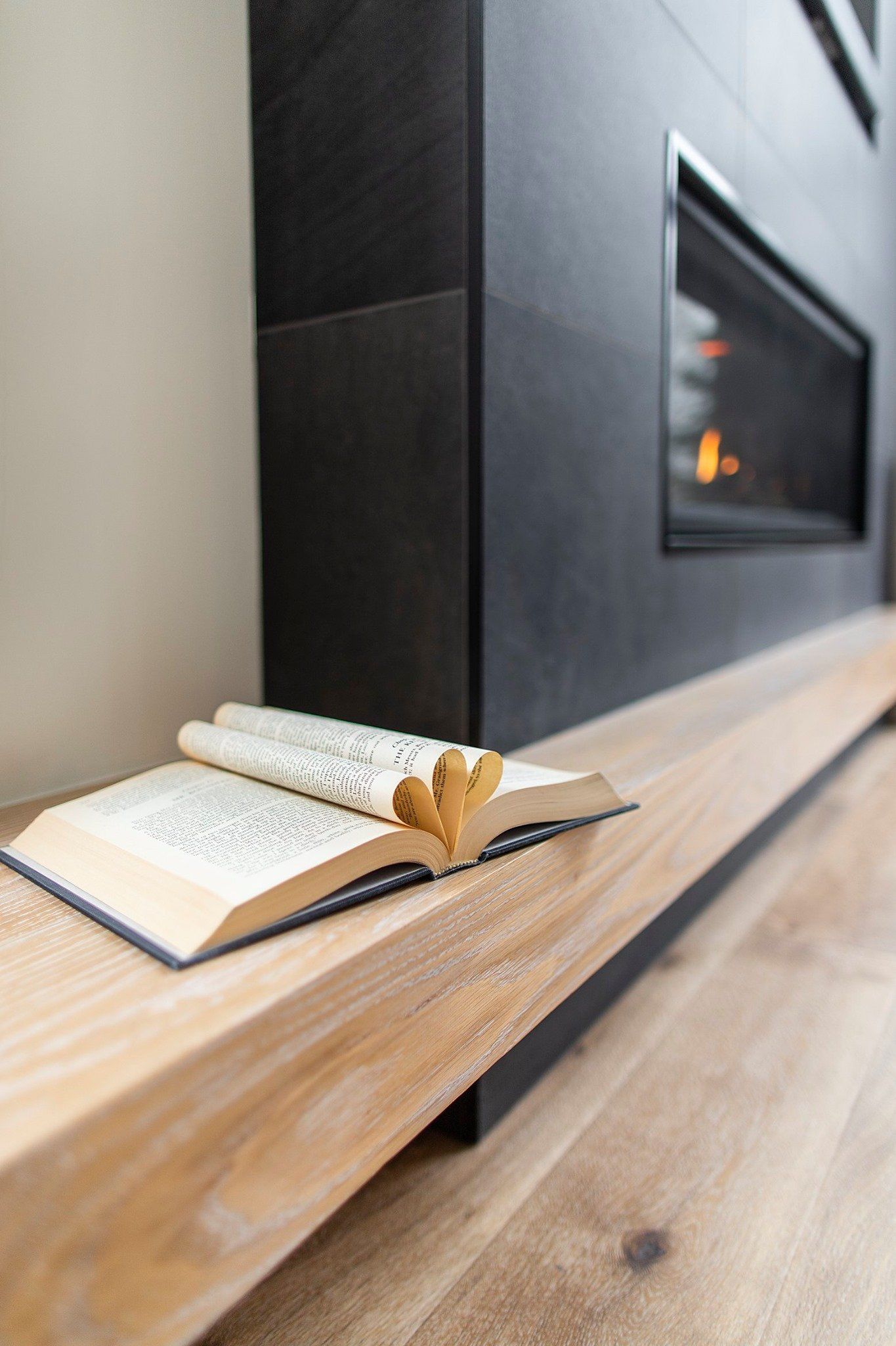 a book with curled up pages by the fireplace