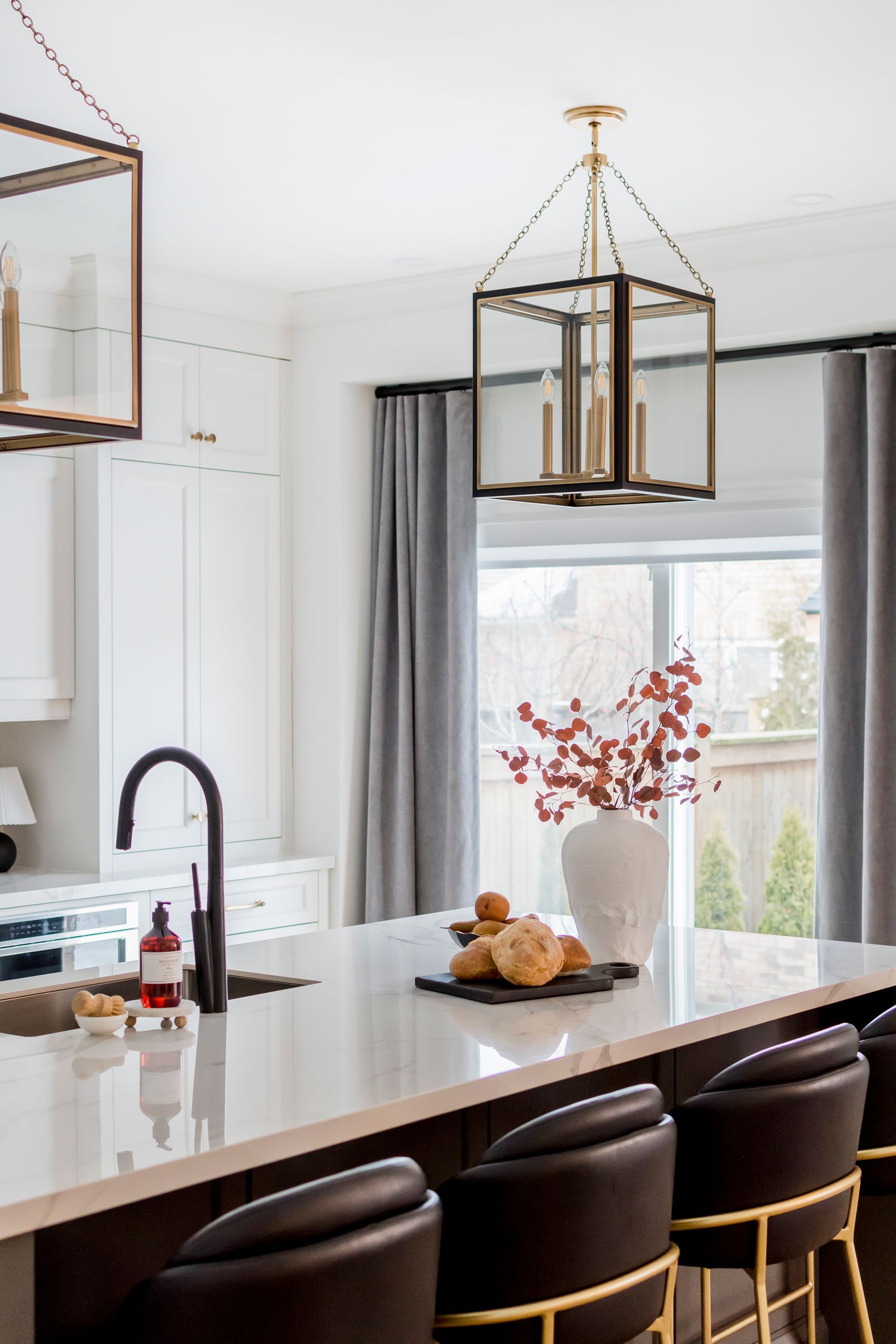 A kitchen with a large island and a sink.