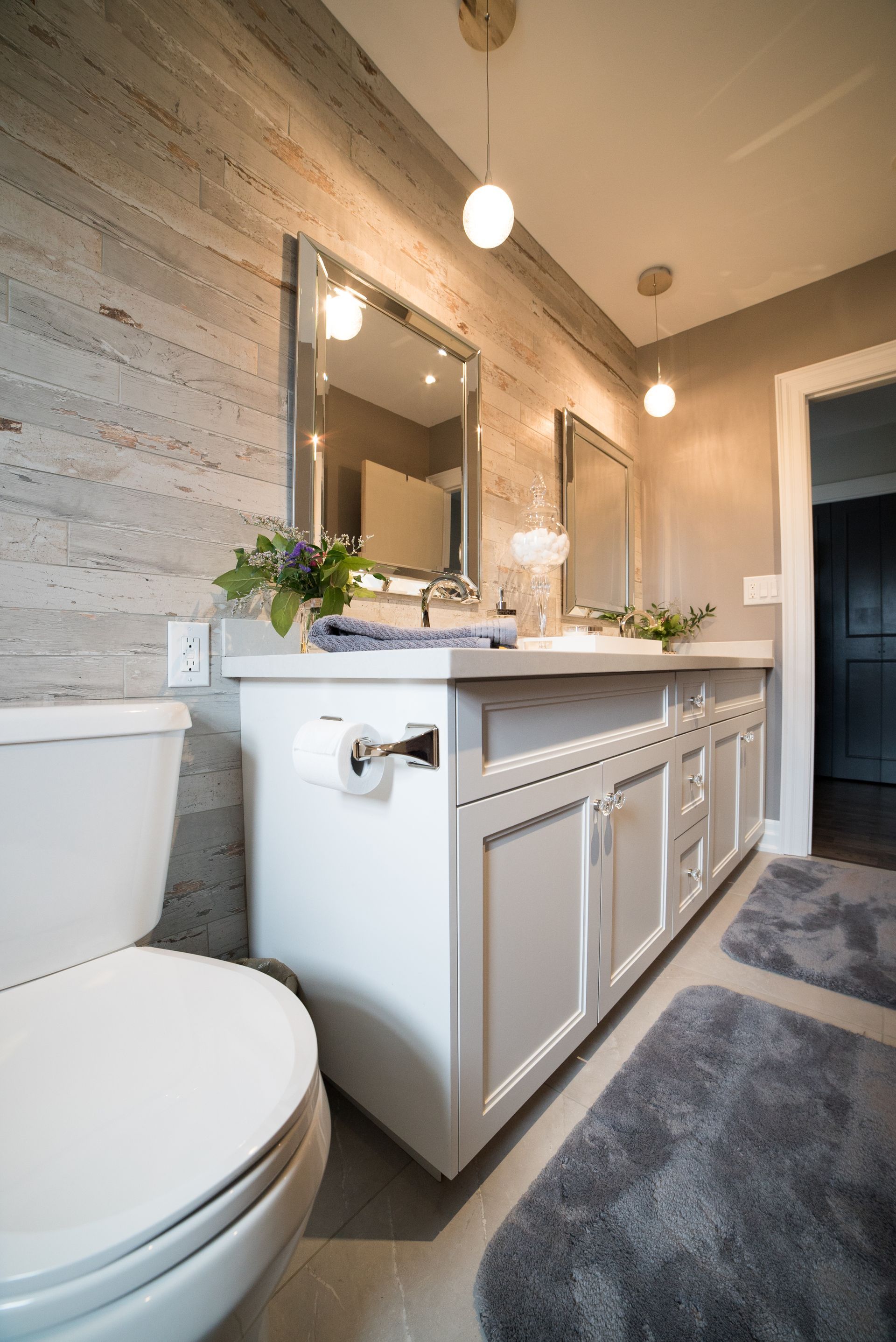 A bathroom with a toilet , sink and mirror