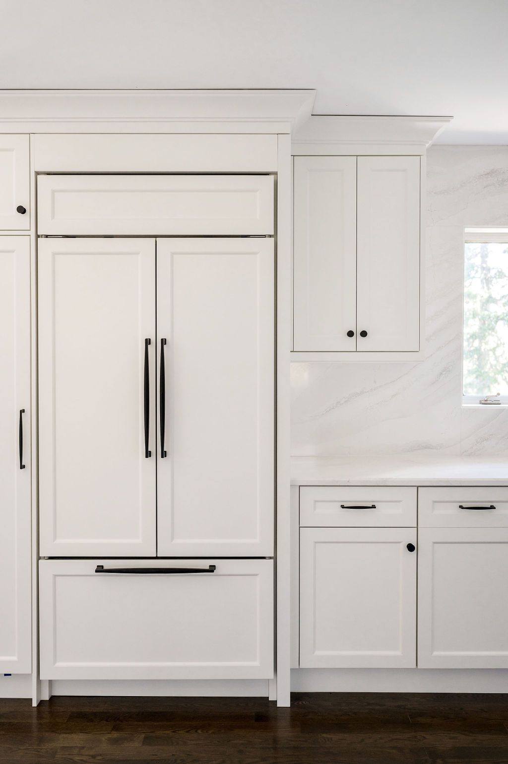 A kitchen with white cabinets and stainless steel appliances