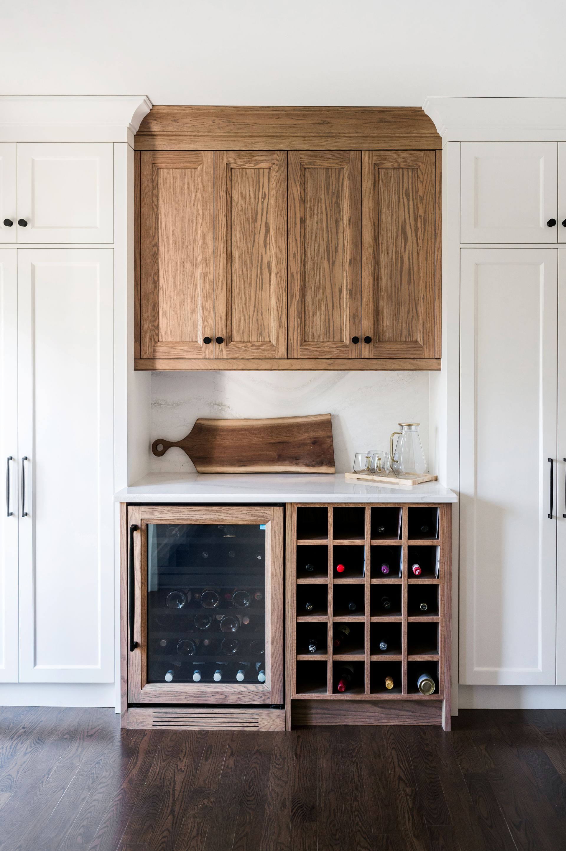 A kitchen with wooden cabinets and a wine cooler