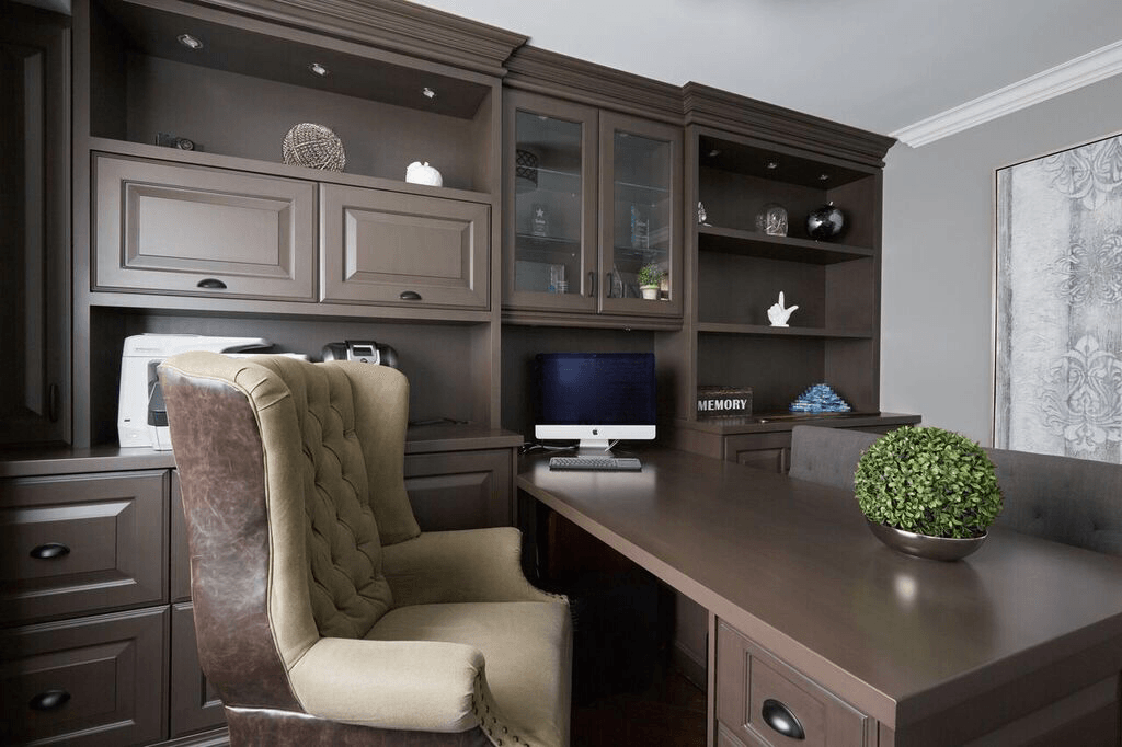 A chair is sitting in front of a desk with a computer on it.