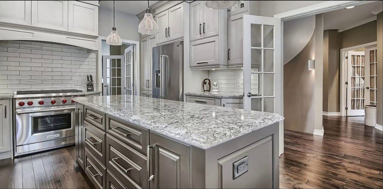A kitchen with stainless steel appliances and granite counter tops.