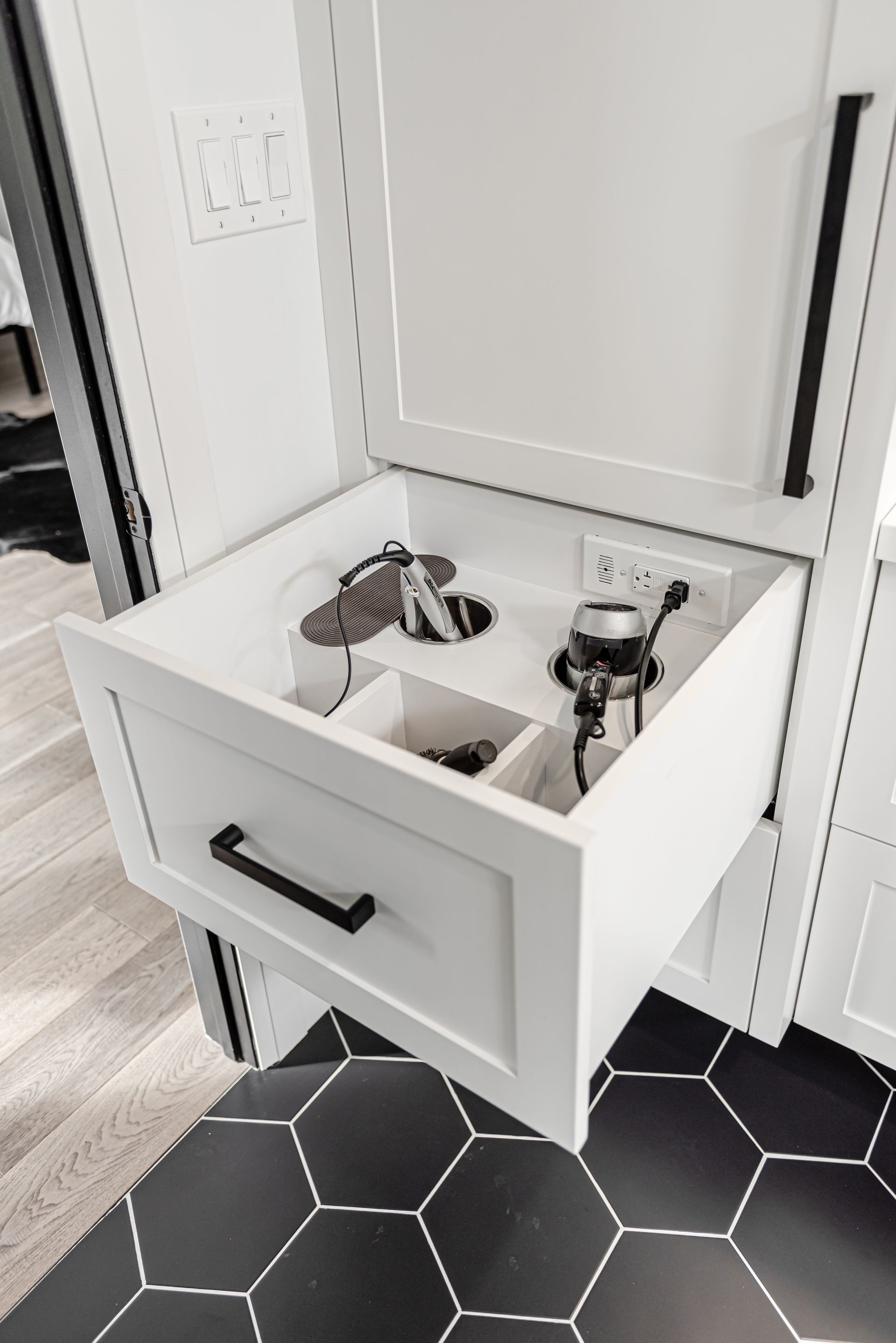 Bathroom vanity drawer with spots for hair tools