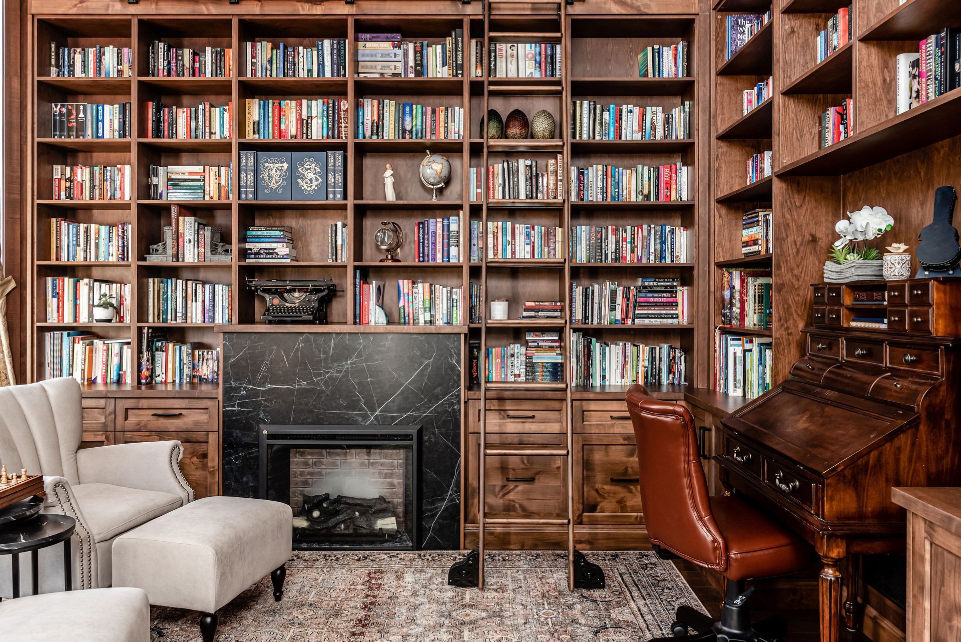 A living room filled with furniture , bookshelves , a fireplace and a piano.