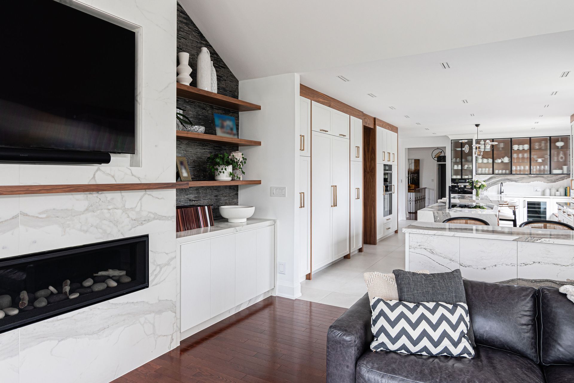 A living room with a couch , fireplace and television.