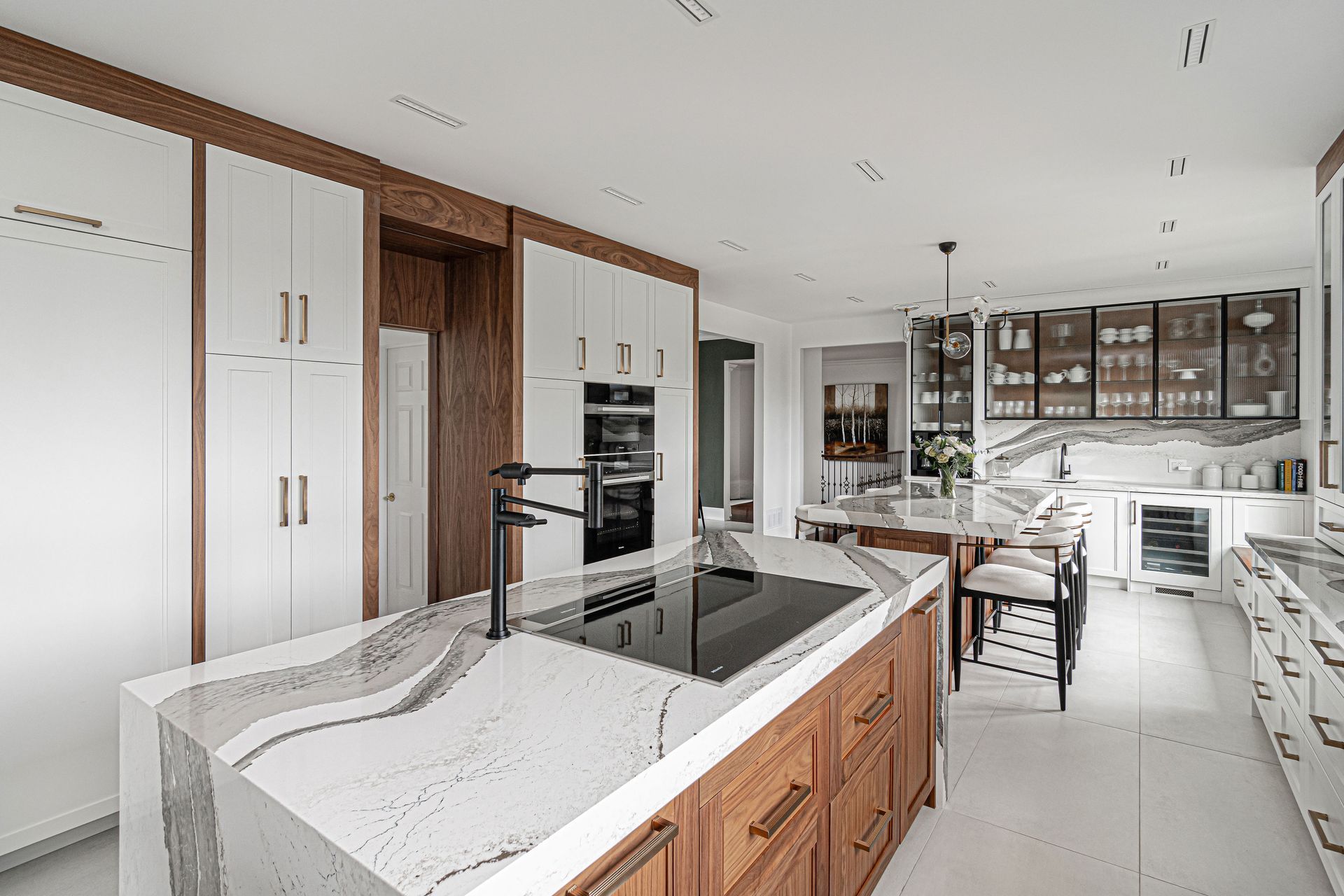 A kitchen with a large island and a stove top oven.