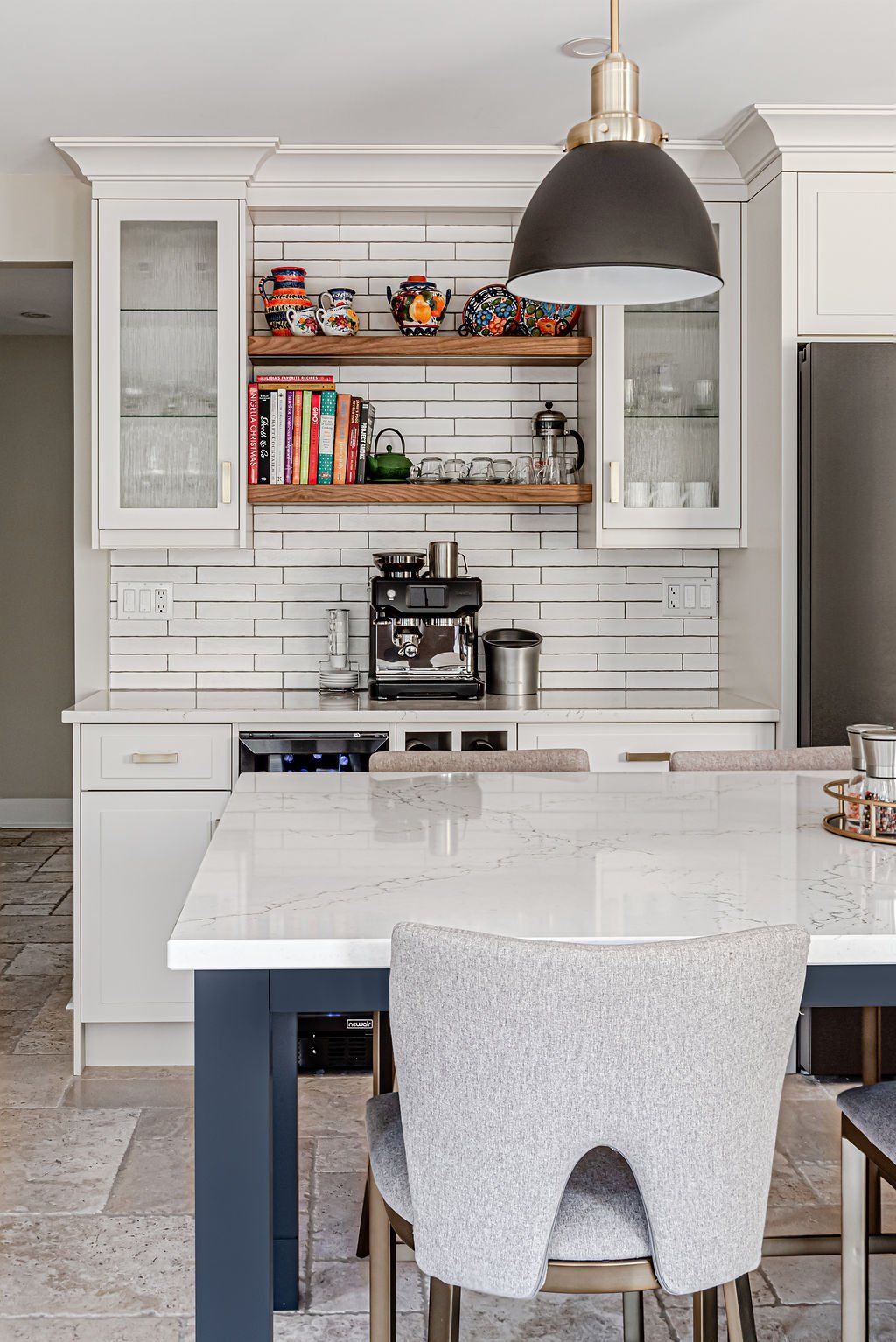 A kitchen with a table and chairs and a coffee maker.