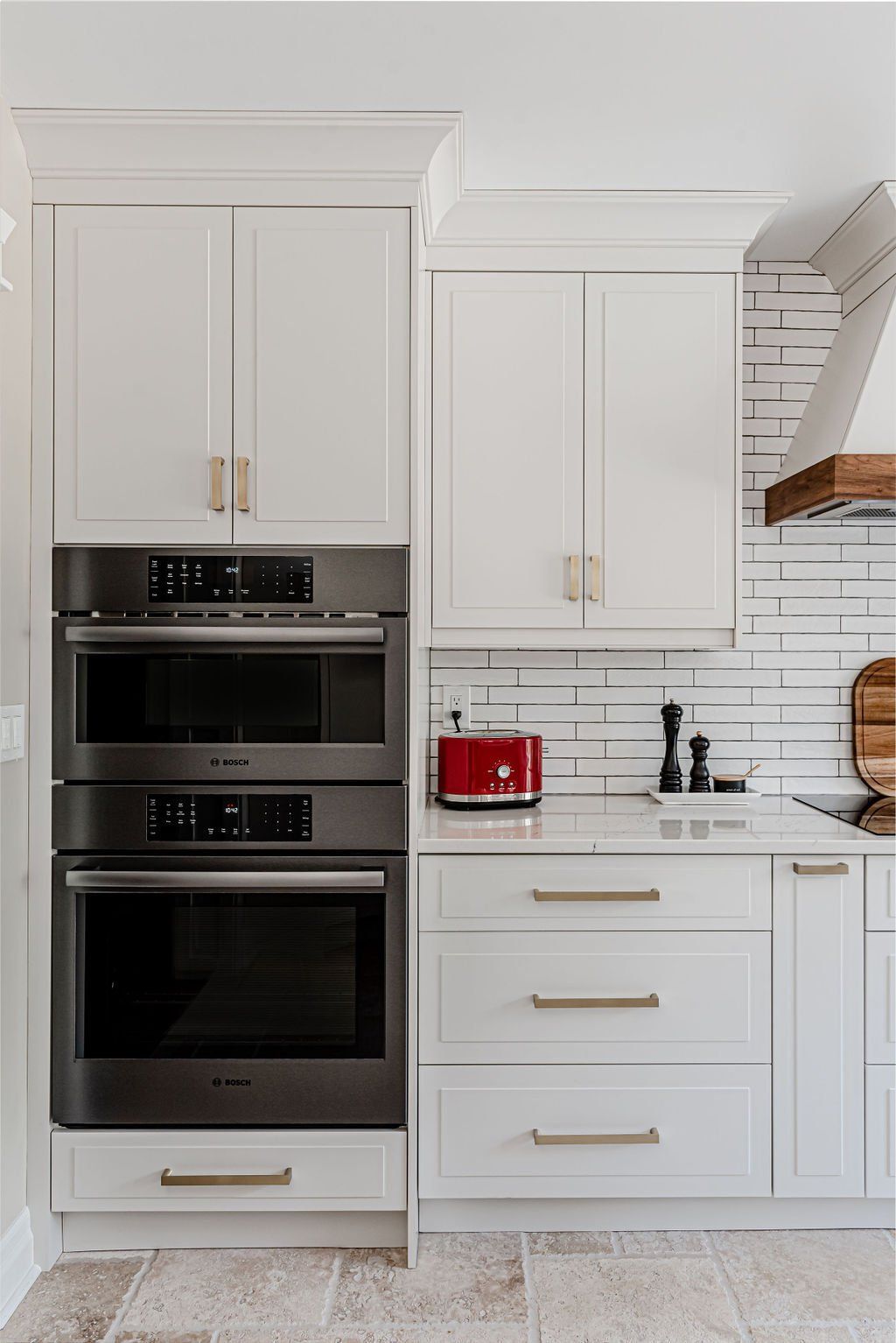 A kitchen with white cabinets and stainless steel appliances.