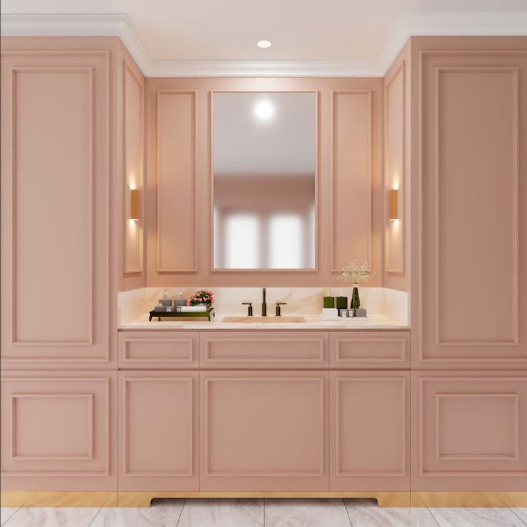 A bathroom with pink cabinets and a sink and mirror