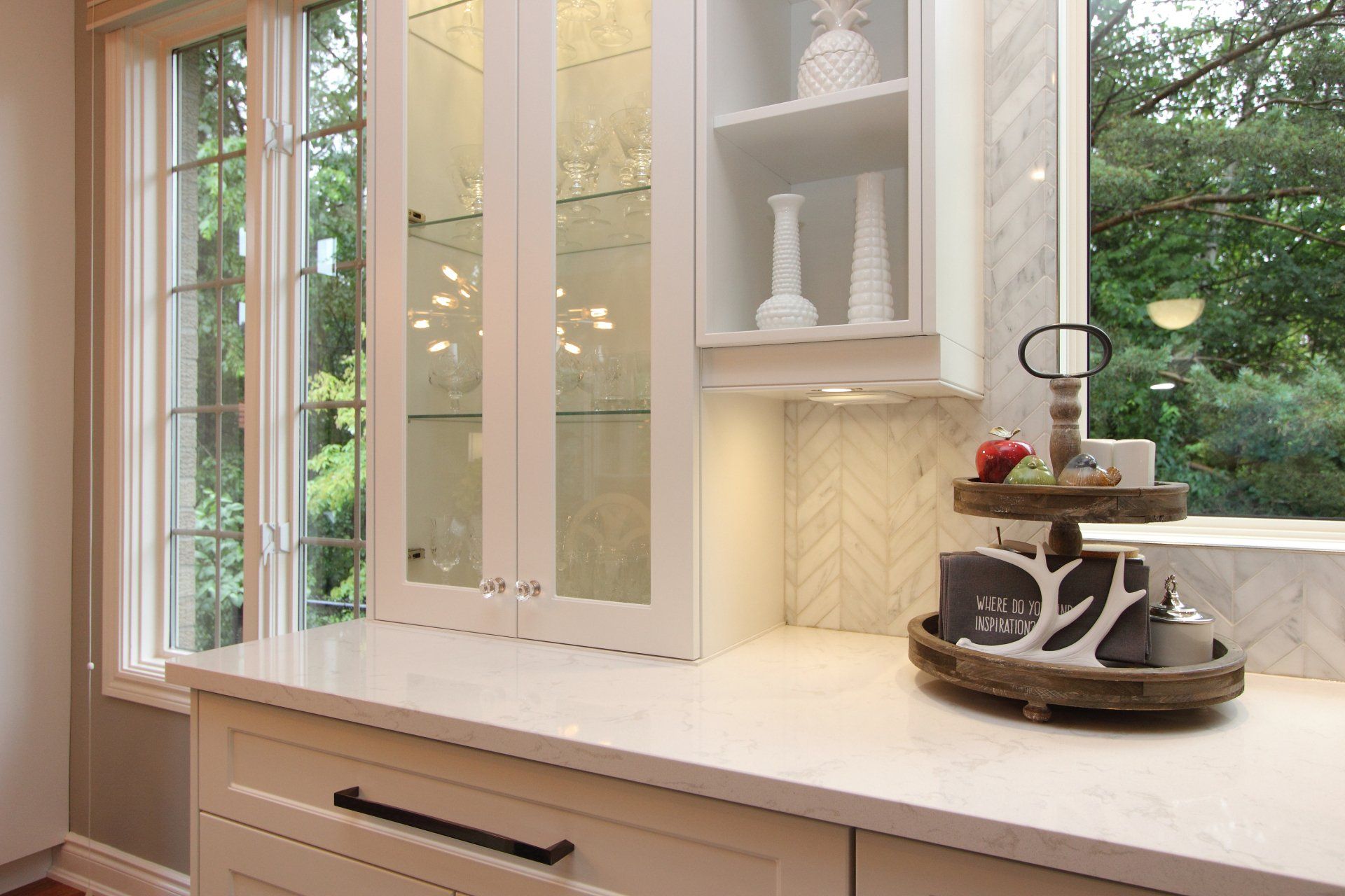 A kitchen with white cabinets and a tray on the counter.