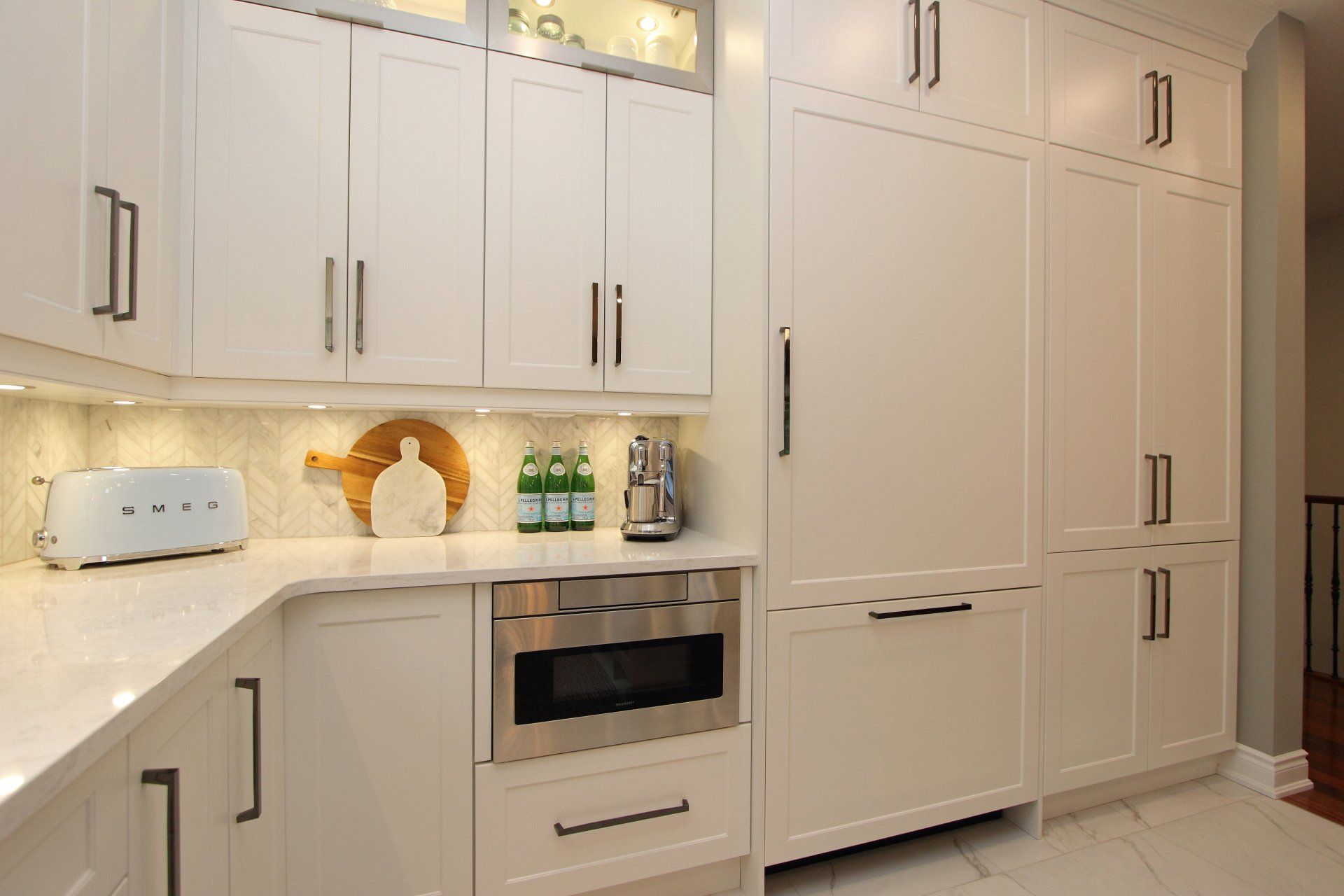A kitchen with white cabinets and stainless steel appliances.