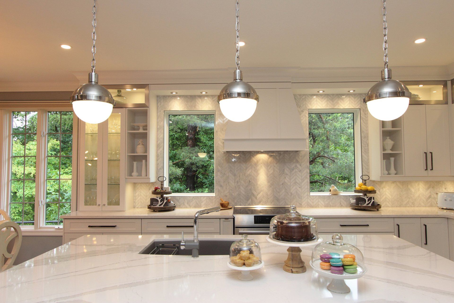 A kitchen with white cabinets and stainless steel appliances