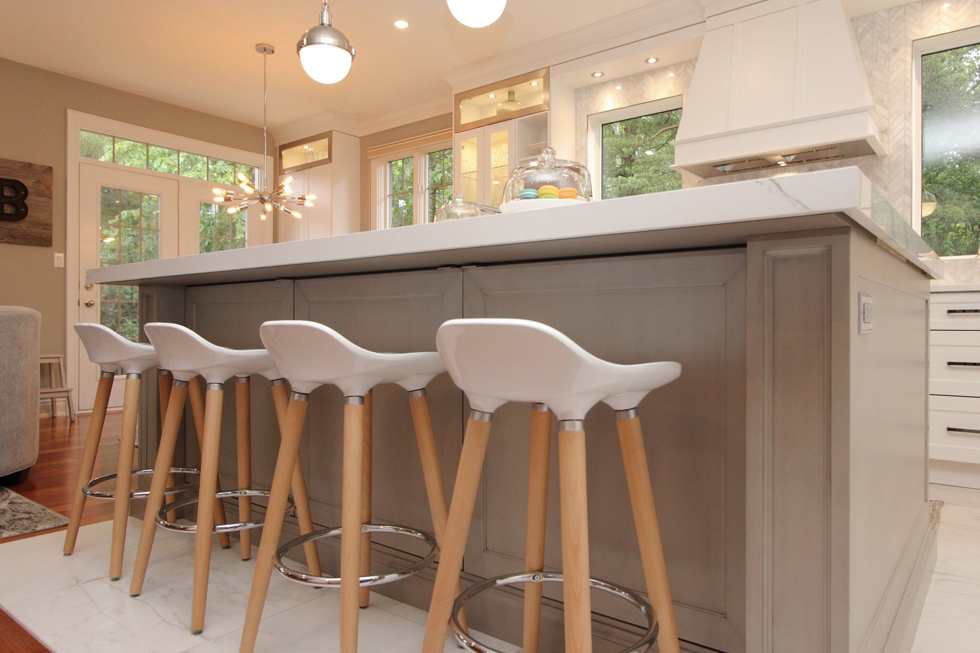 A kitchen with a long island and stools on it