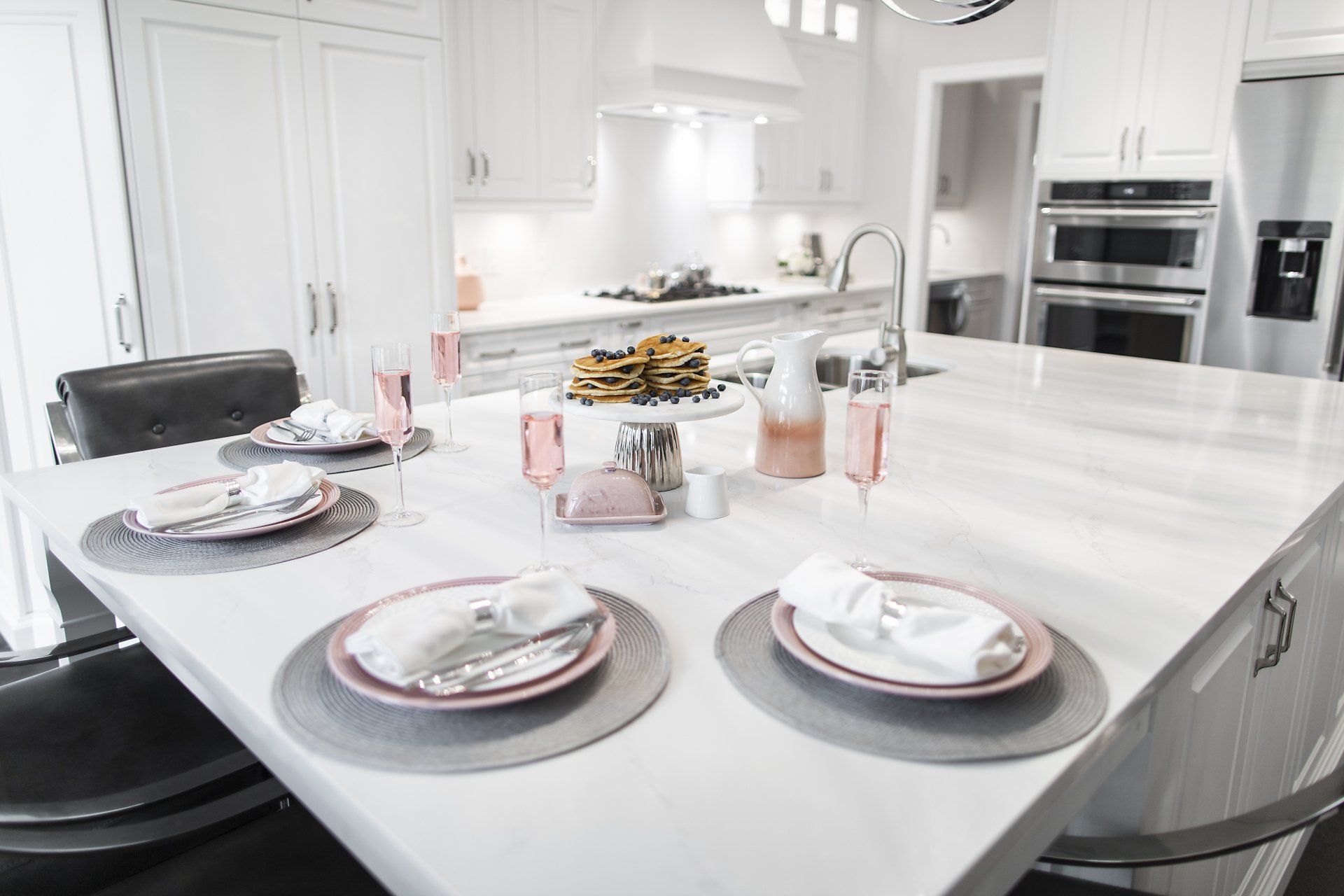 A kitchen with a large island and plates on it.