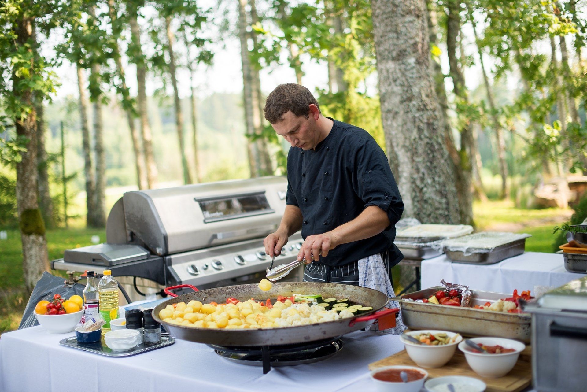 person cooking on grill  outdoor kitchen