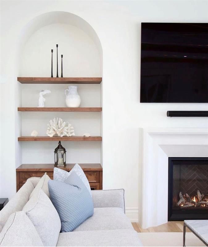 A living room with a fireplace and a flat screen tv