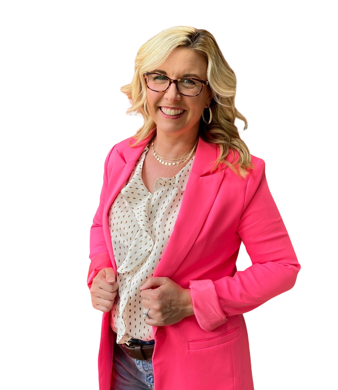 A woman wearing glasses and a pink jacket is smiling.
