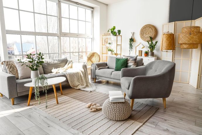 A living room filled with furniture and a large window.