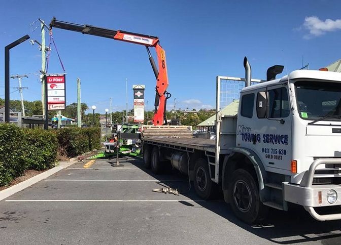 A Truck With a Crane on the Back is Parked in a Parking Lot — Trucking Crane Trucks in Caloundra, QLD