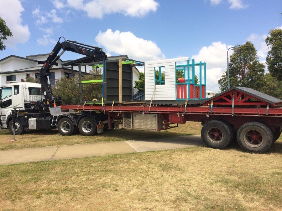 A Truck is Carrying a Playhouse on a Trailer — Trucking Crane Trucks in Warana, QLD