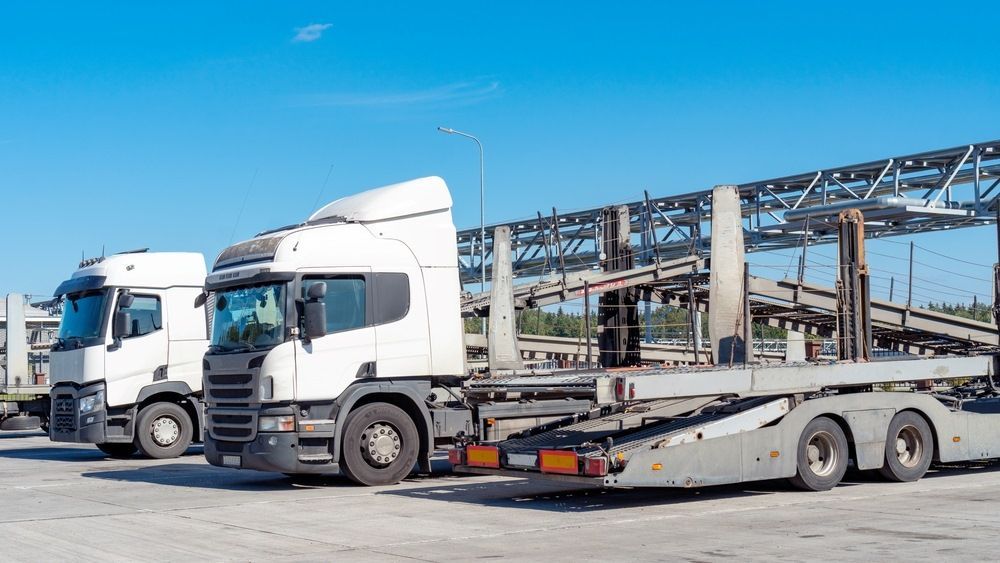 Two Semi Trucks Are Parked Next to Each Other in a Parking Lot — Trucking Crane Trucks in Nambour, QLD